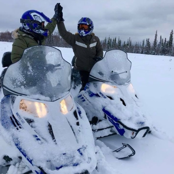 a group of people sitting in the snow
