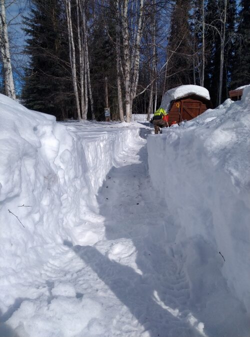 a man riding on top of a snow covered slope