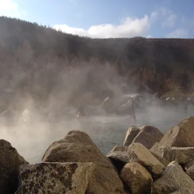 a pile of snow with a mountain in the background