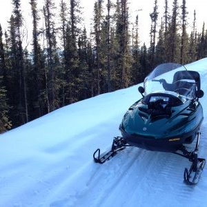 A man riding skis down snow-covered slope near Fairbanks Alaska