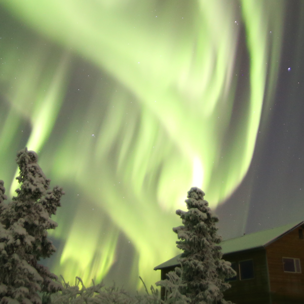 Rainbow-colored northern lights arching across night sky near Fairbanks Alaska