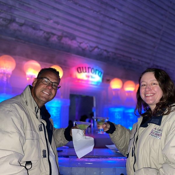 Couple sharing a drink and toasting with smiles in Fairbanks Alaska
