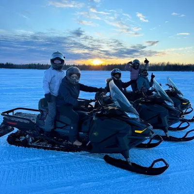 a group of people sitting on a motorcycle in a body of water