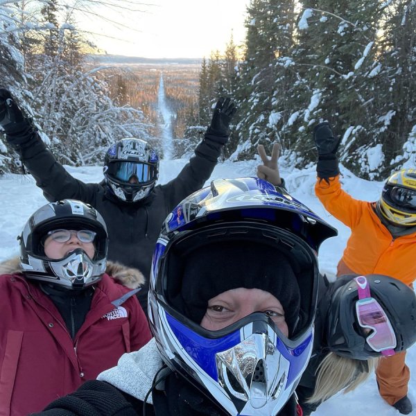 a couple of people that are standing in the snow