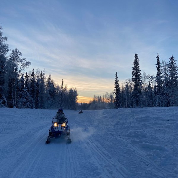 a person riding skis down a snow covered slope