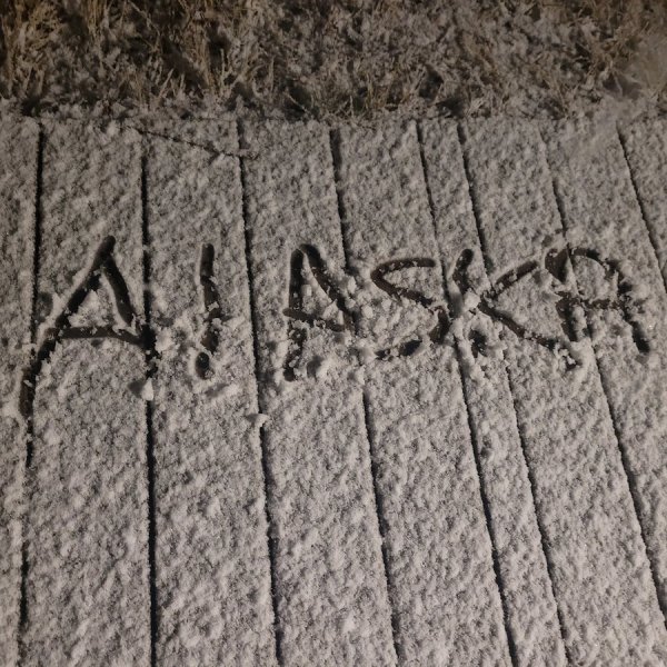 Alaska handwritten in sand on ground near Fairbanks Alaska