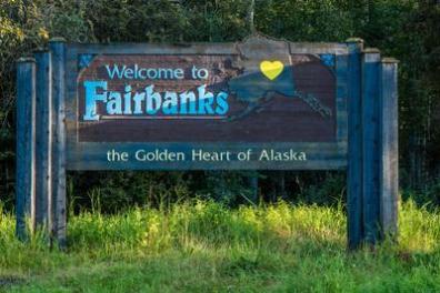 Sign reads 'Welcome to Fairbanks, the Golden Heart of Alaska' with a yellow heart on Alaska's silhouette.