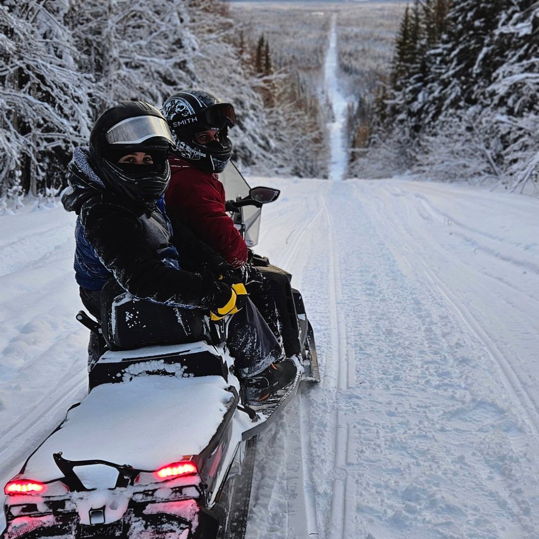 Two people on a snowmobile on a tour from Fairbanks Alaska